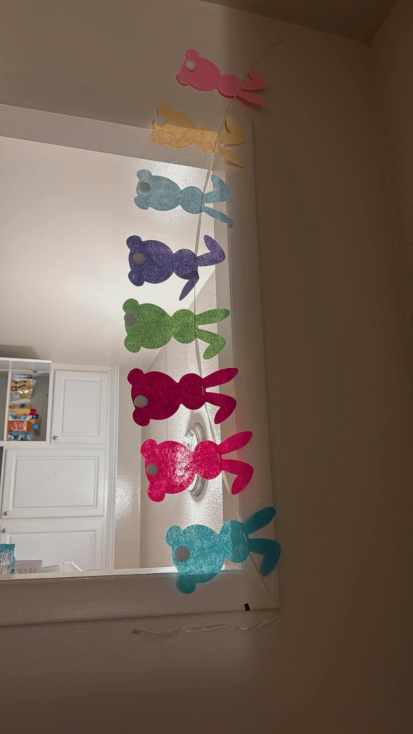Colorful teddy bear cutouts hanging vertically