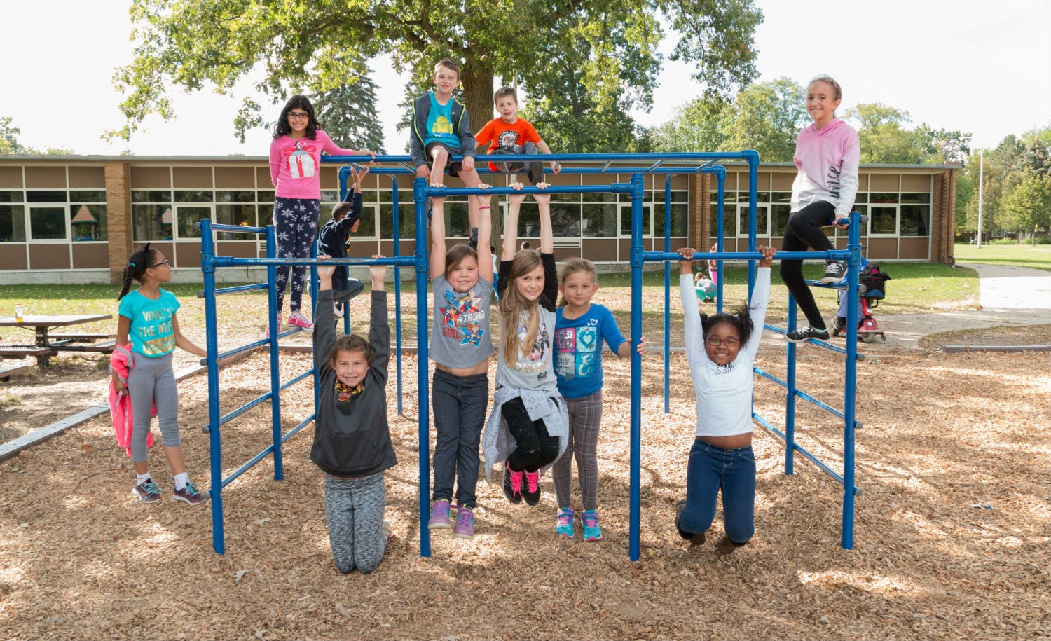 Children playing on monkey bars on a playground