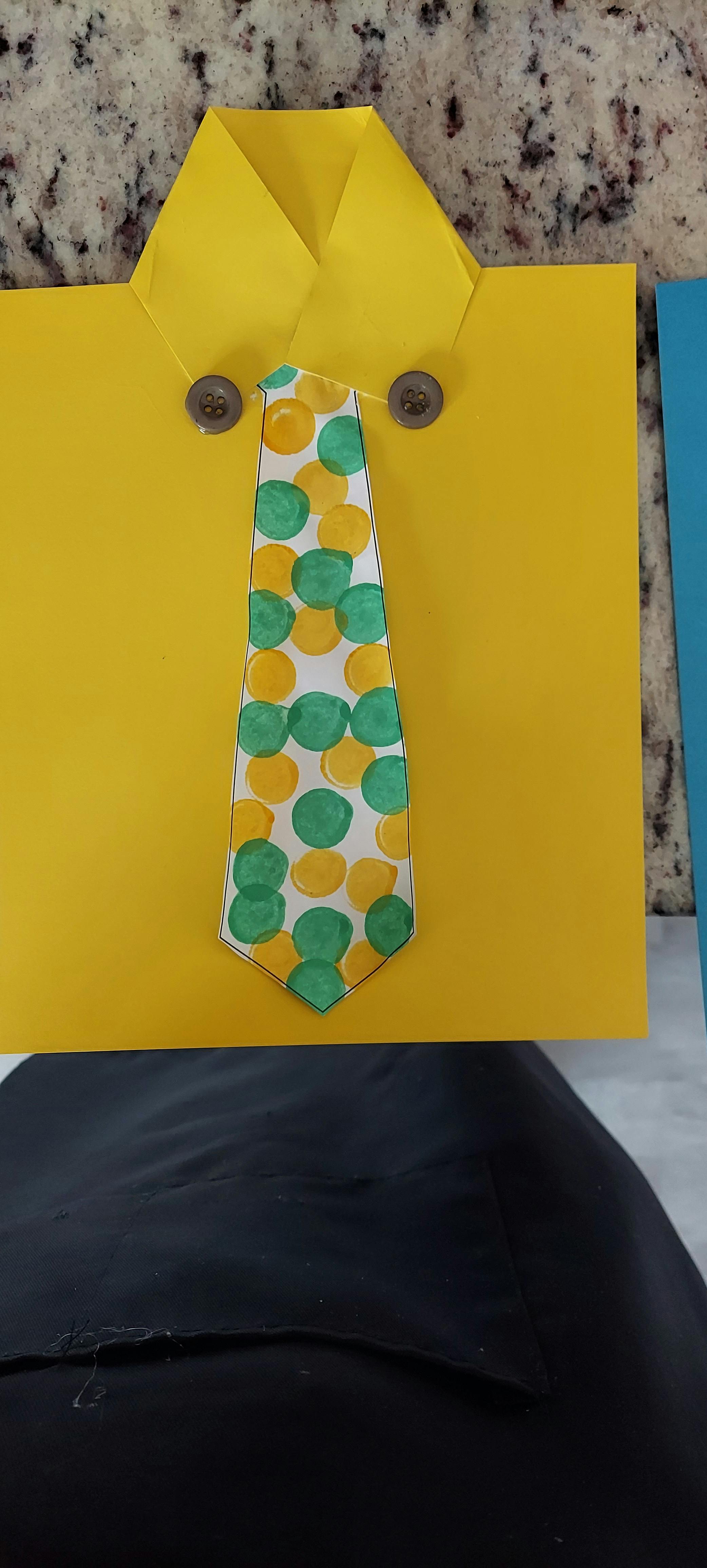 Yellow paper craft shirt with a polka dot tie and two buttons