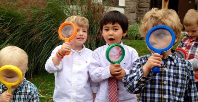 Children holding magnifying glasses