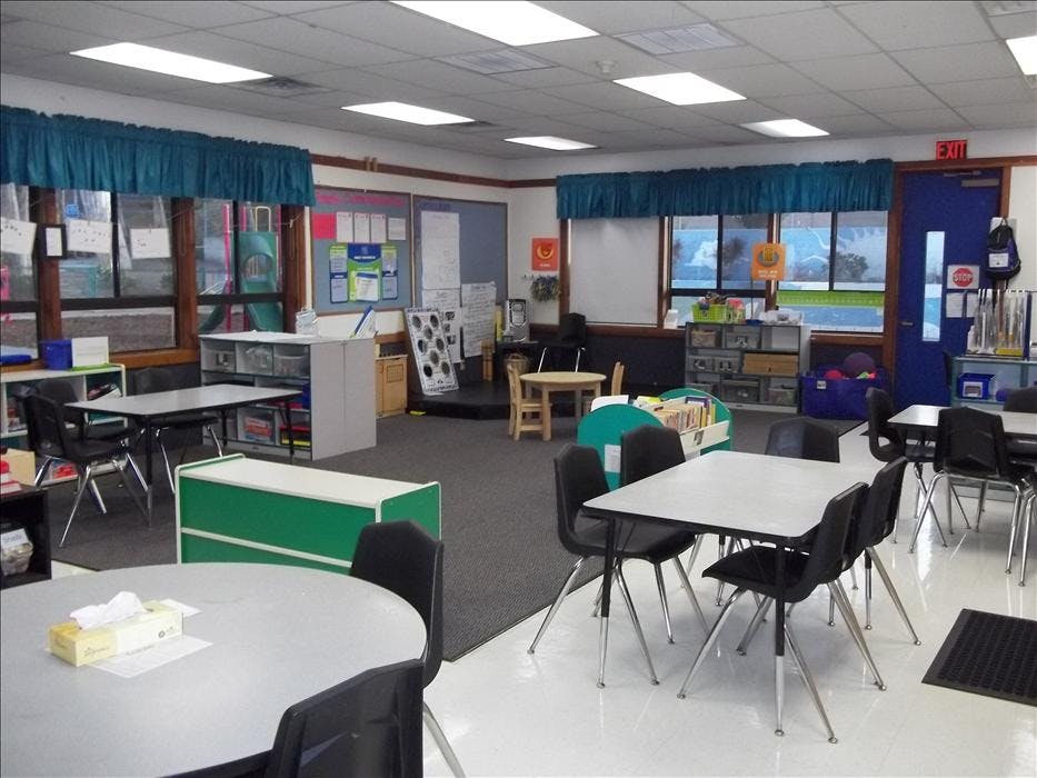 Empty classroom with tables and chairs