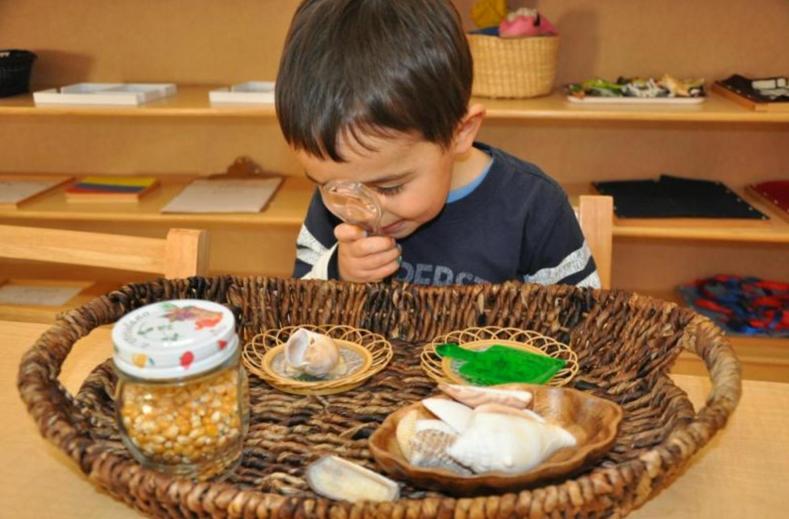 Child looking at items in a woven basket