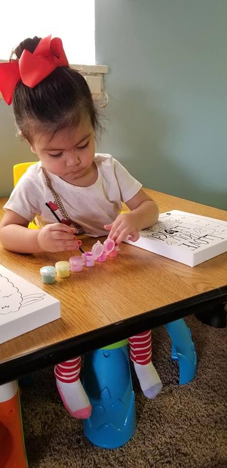 Child painting at a table