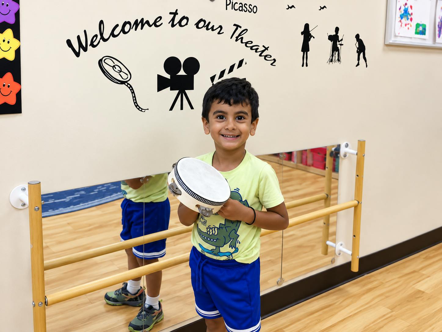 Child holding a tambourine in front of a mirror in a classroom