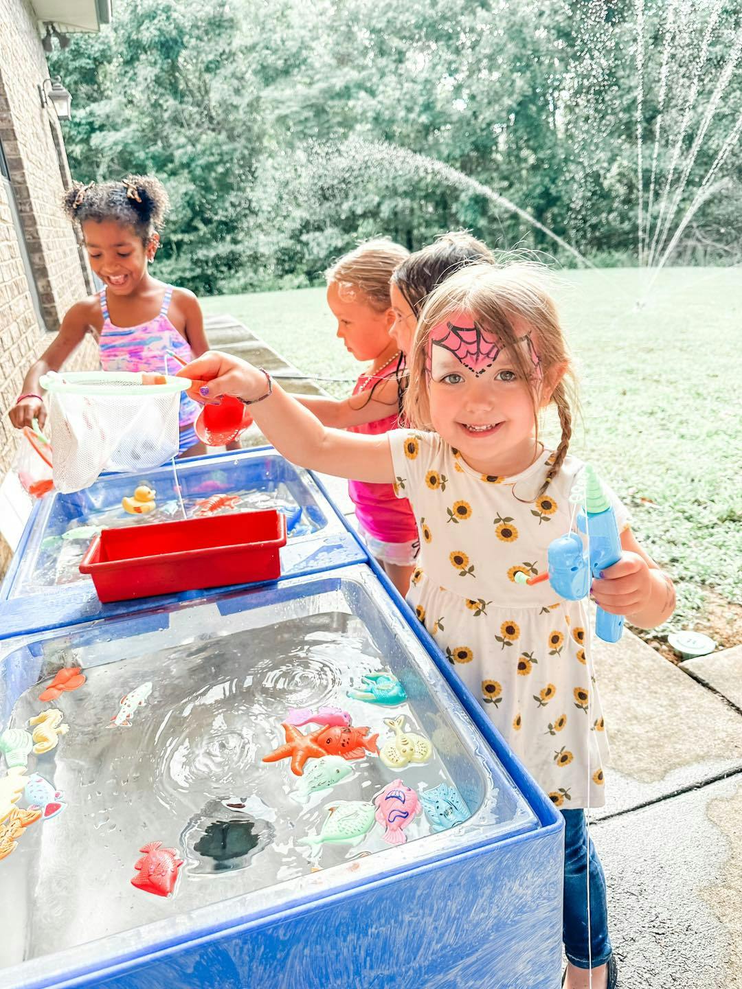 Children playing with water table toys