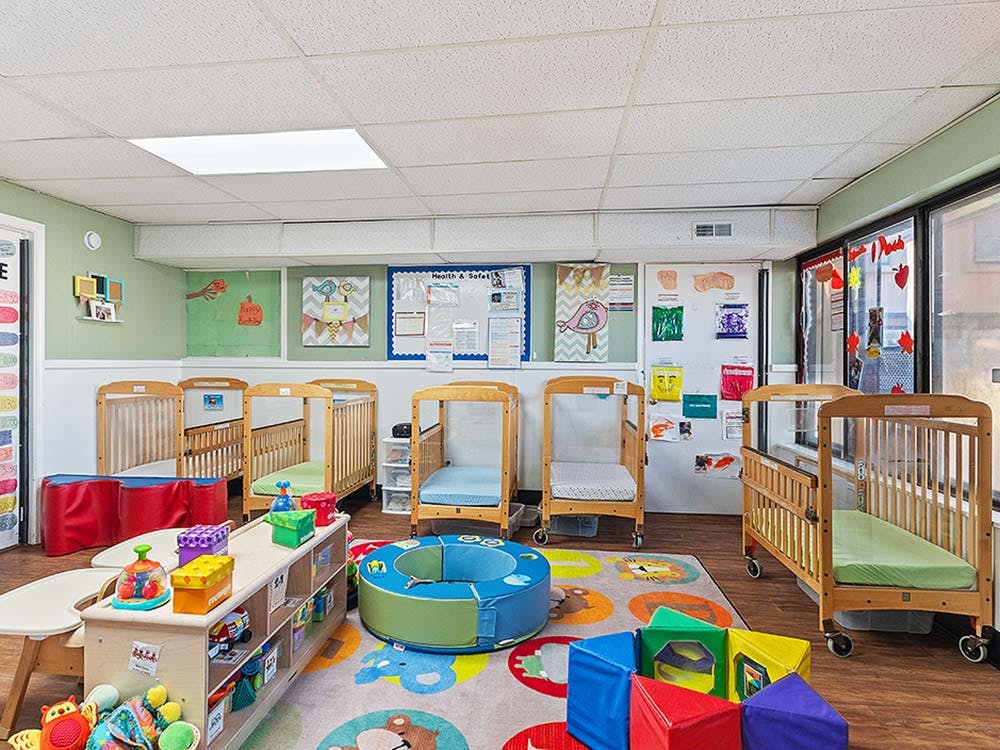 Cribs and colorful toys in a daycare