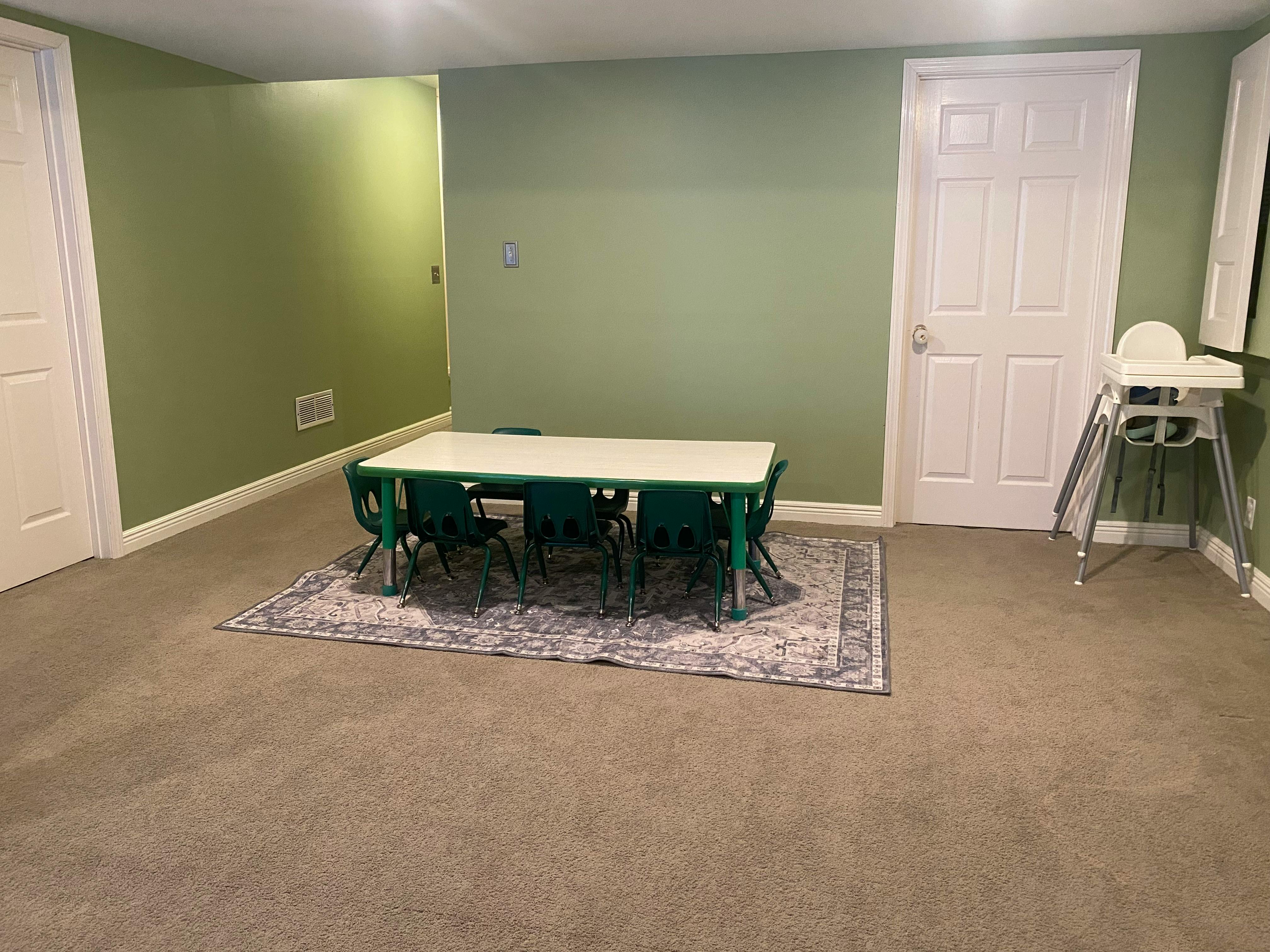 Children's table and chairs on a rug in a room