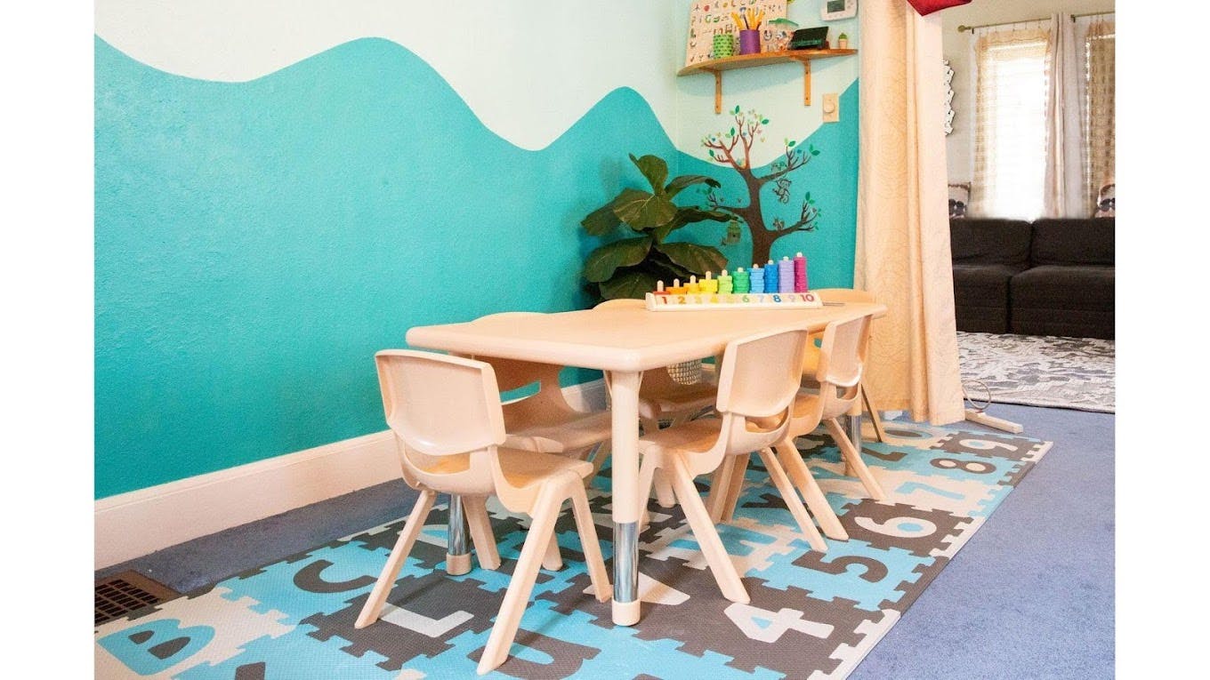 Children's table and chairs in a room with a painted wall