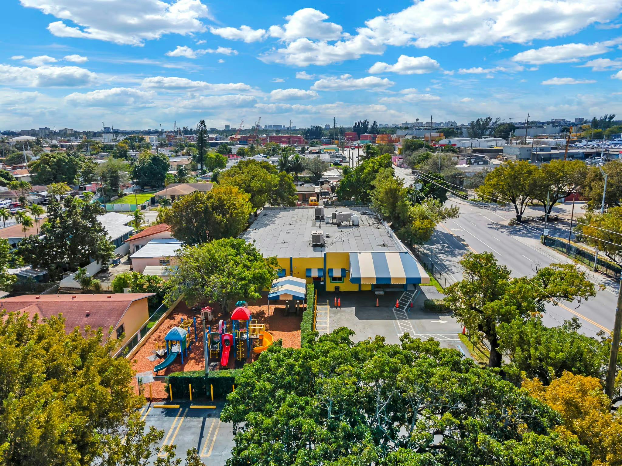Aerial view of a building with a playground and a street