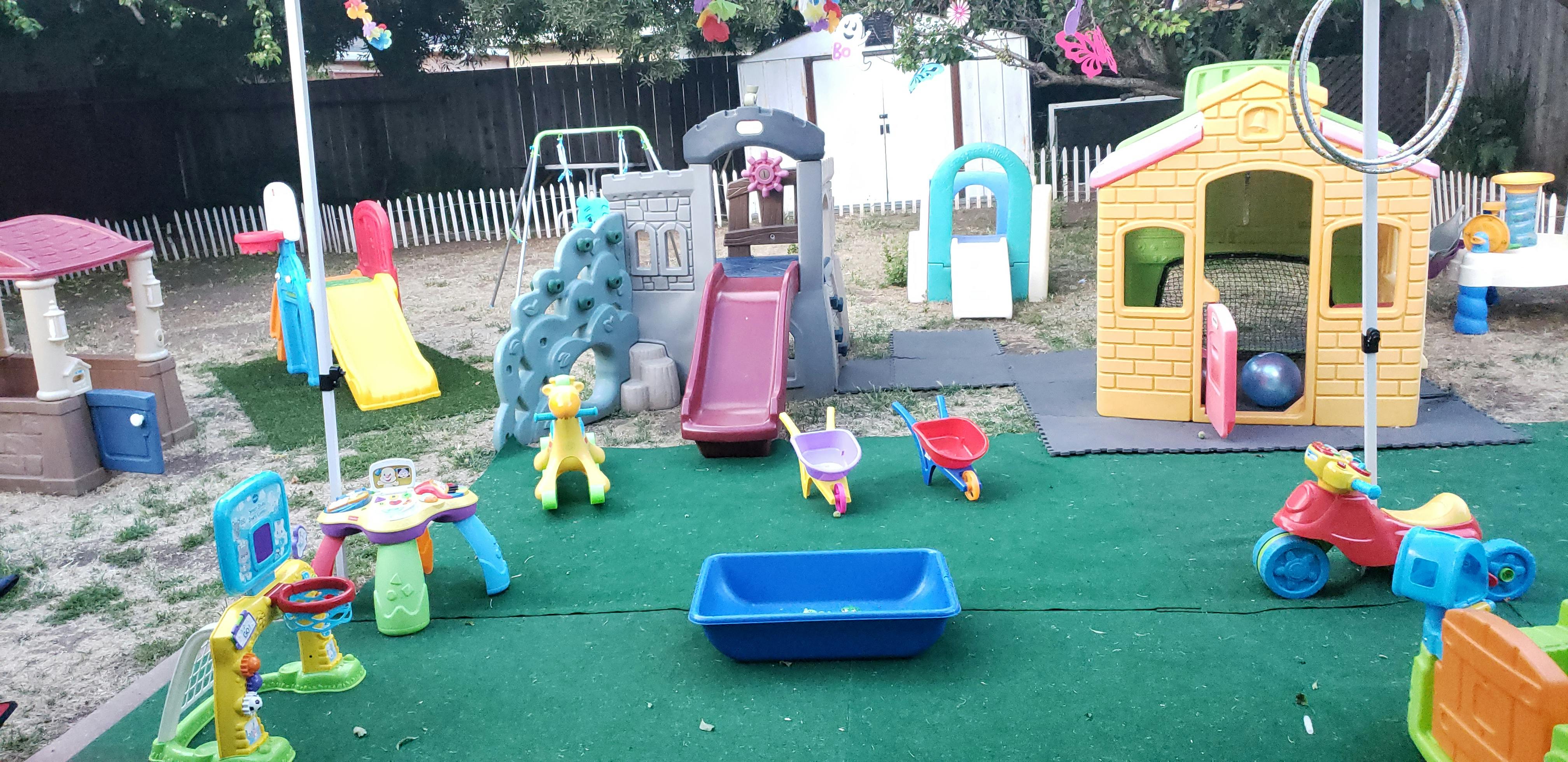 Outdoor playground with various play structures and toys