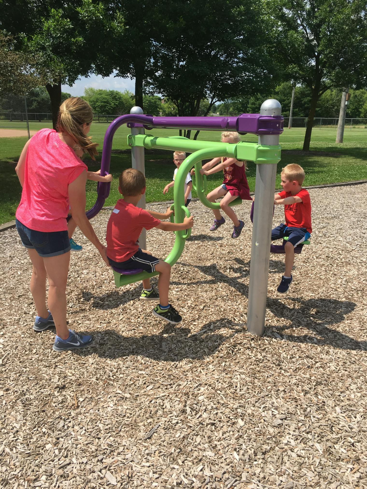 Adult and children on playground equipment