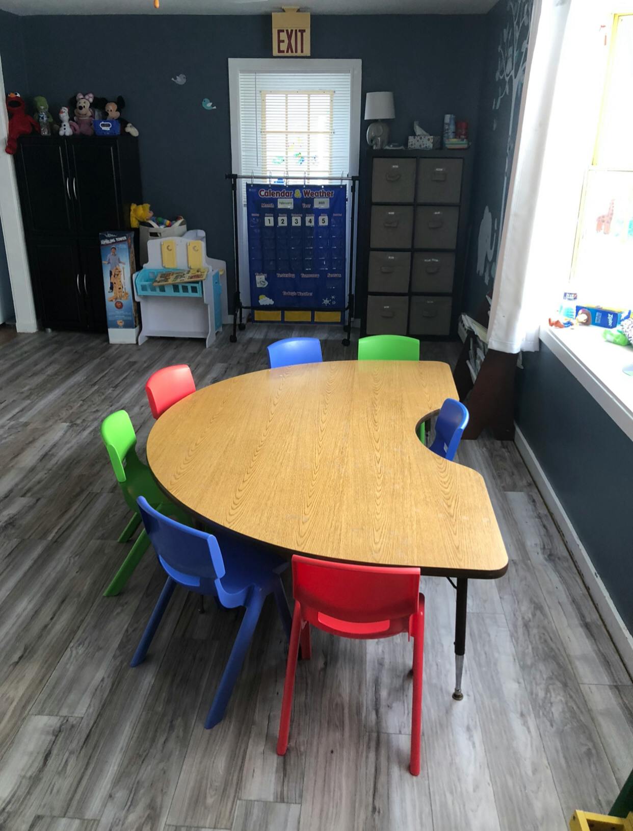 Classroom with a crescent-shaped table and colorful chairs
