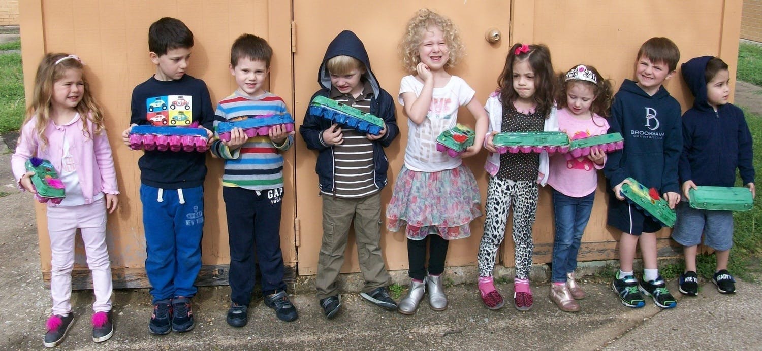Group of children holding egg cartons