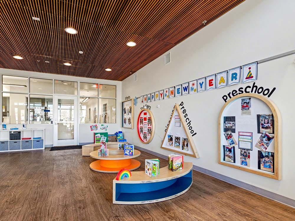 Preschool classroom interior with displays on walls and child-height tables