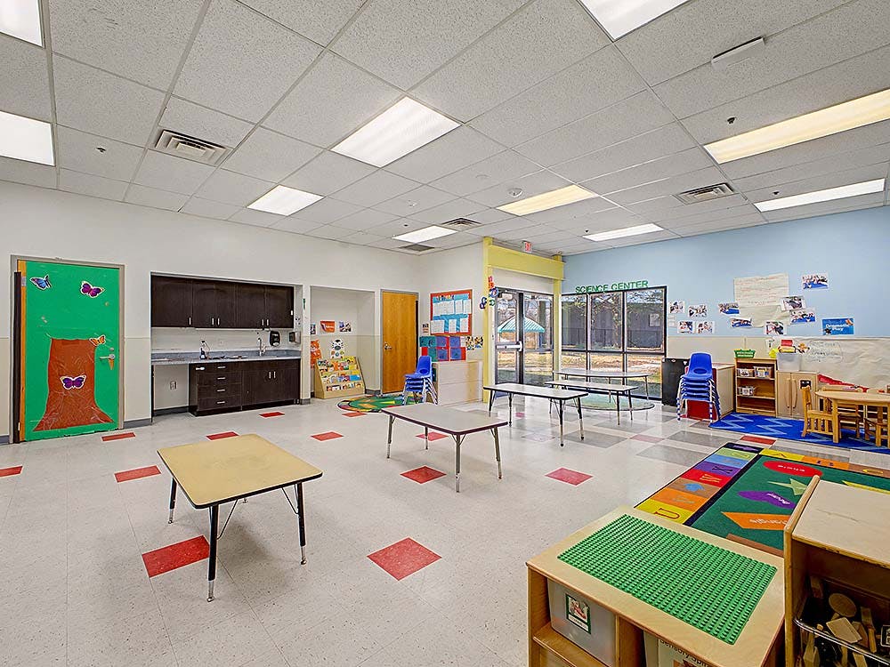 Classroom with small tables, chairs, and colorful decorations