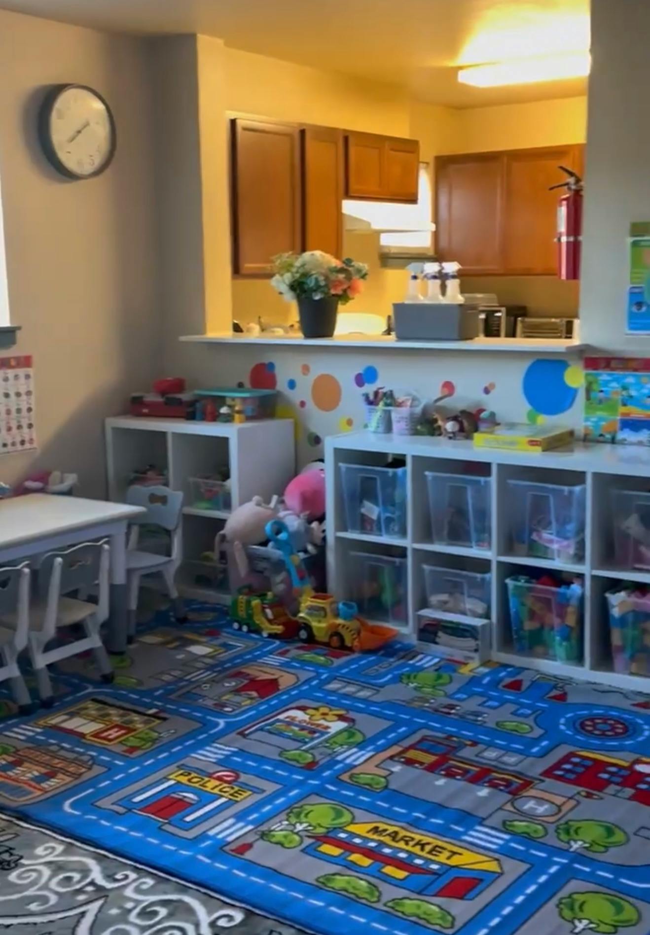 Playroom with a road map rug, toy storage, and a small table with chairs