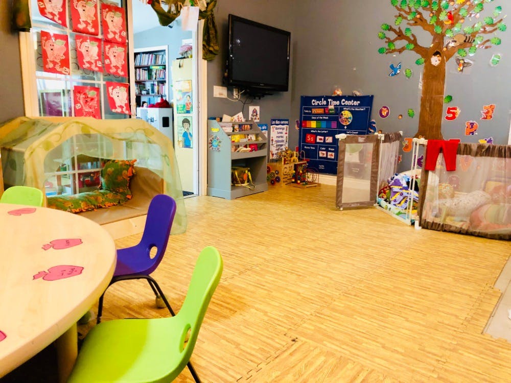 Playroom with small table and chairs, play tent, and wall decorations