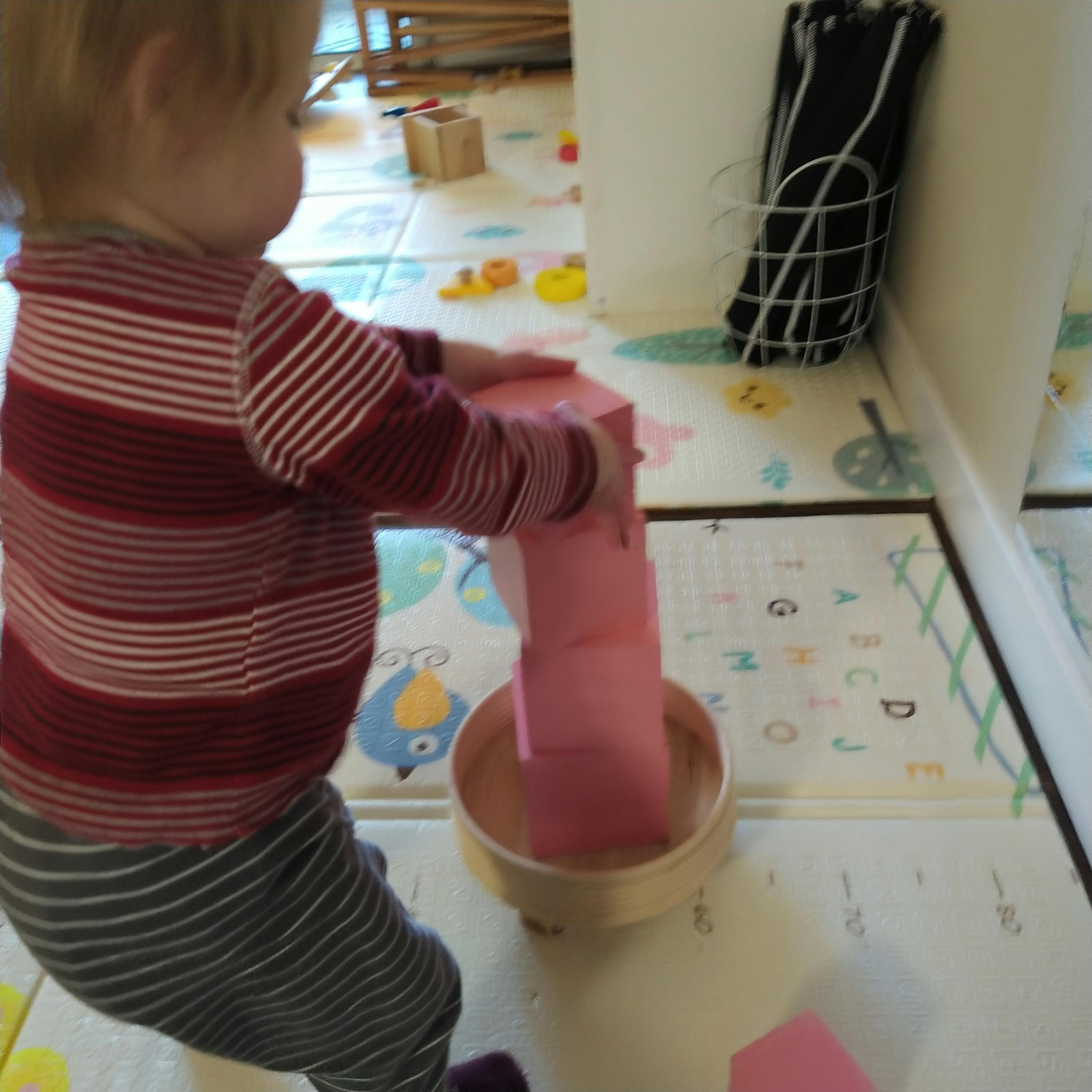 Child playing with pink blocks