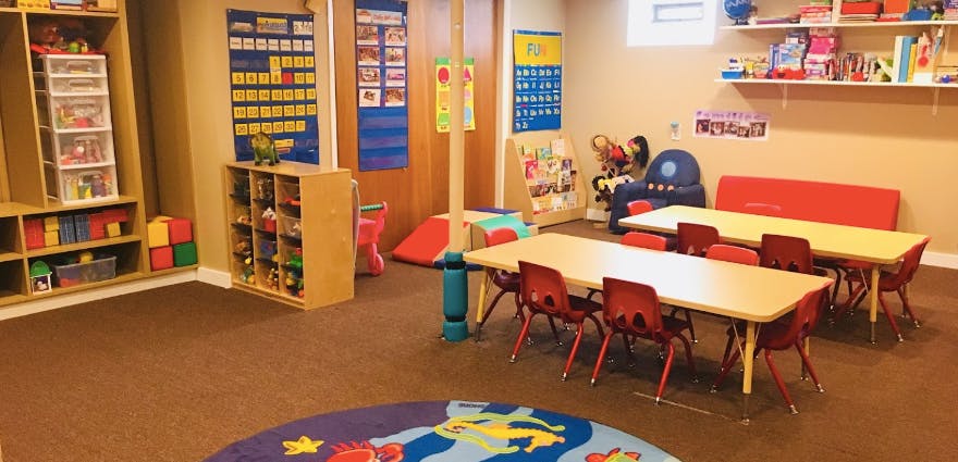 Playroom with tables, chairs, and toys