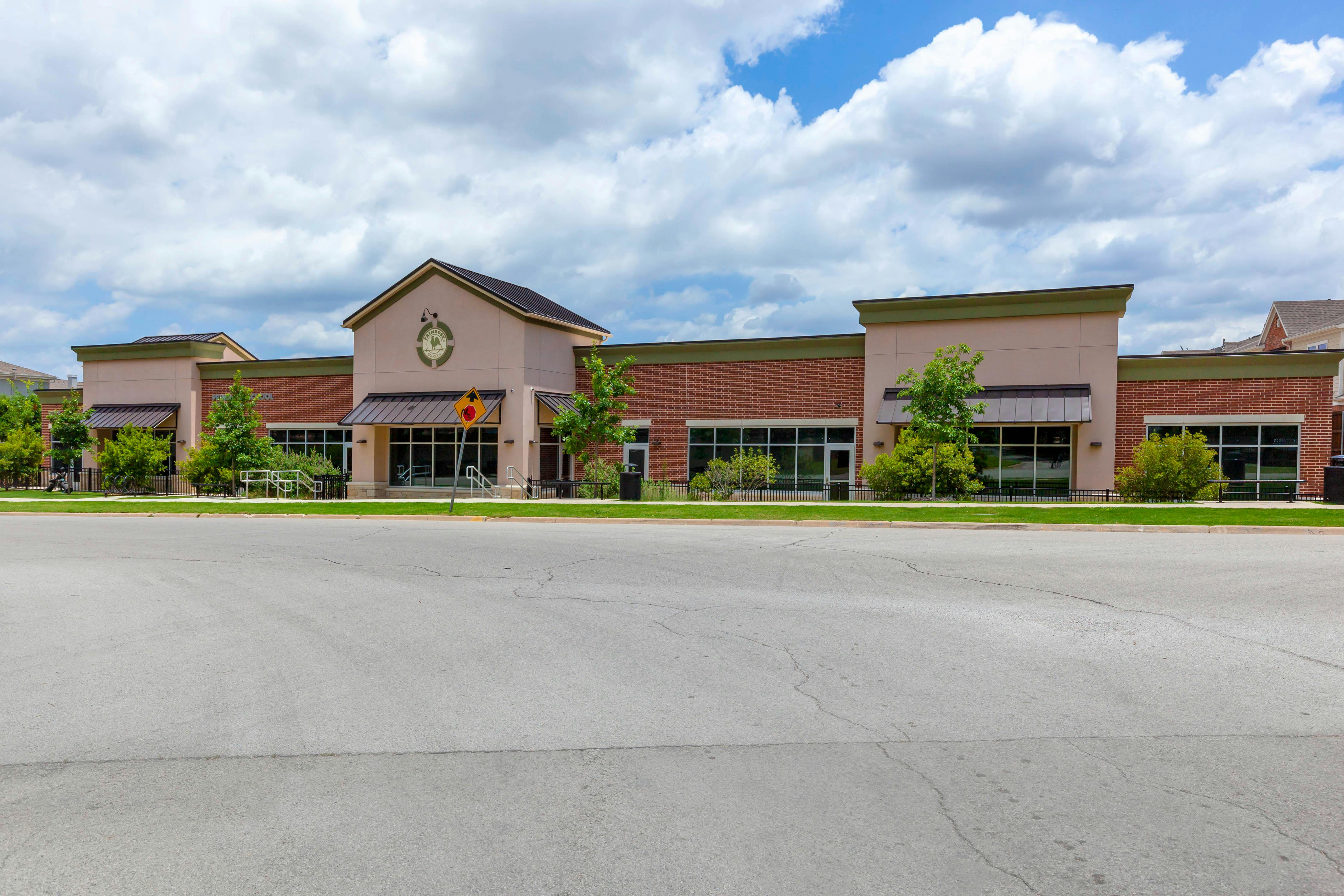 Primrose School building exterior with brick and stucco, under a cloudy sky