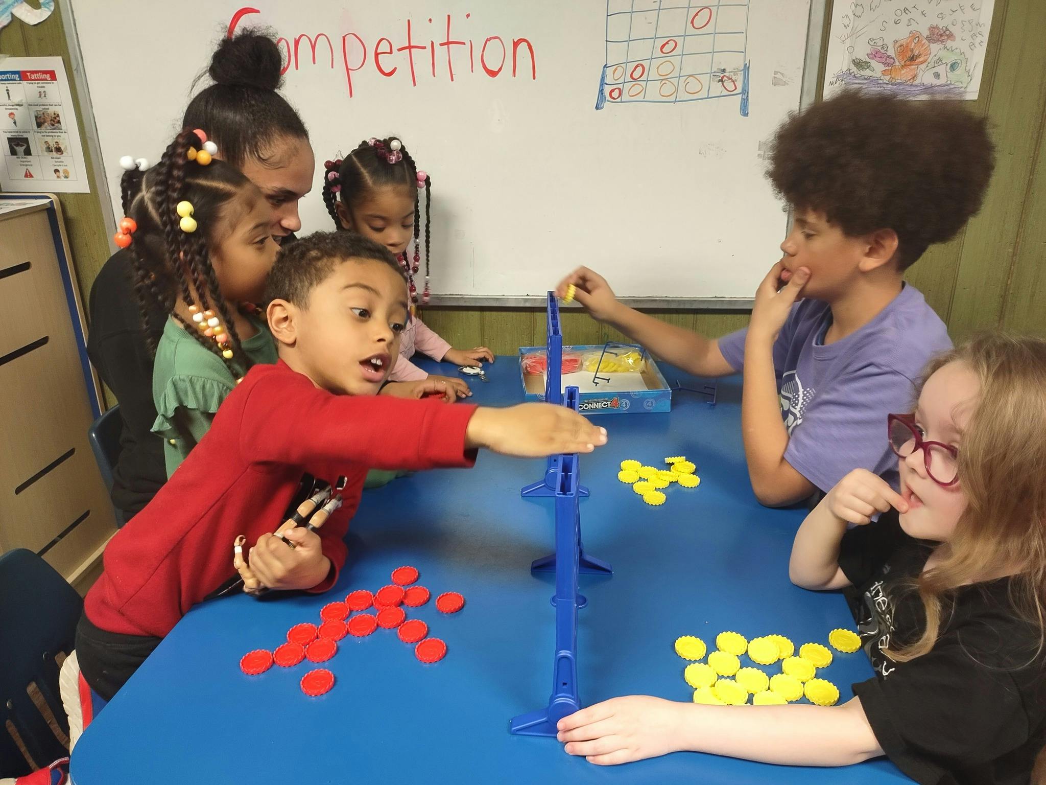 Children playing a board game at a table