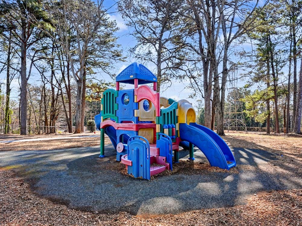 Colorful playground structure with slides on wood chips