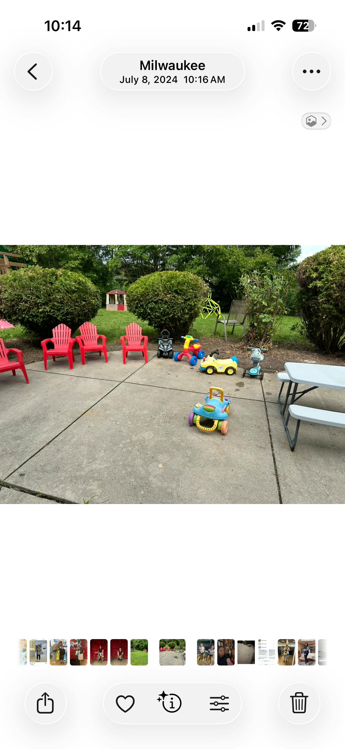 Patio with red chairs, ride-on toys, and a picnic table