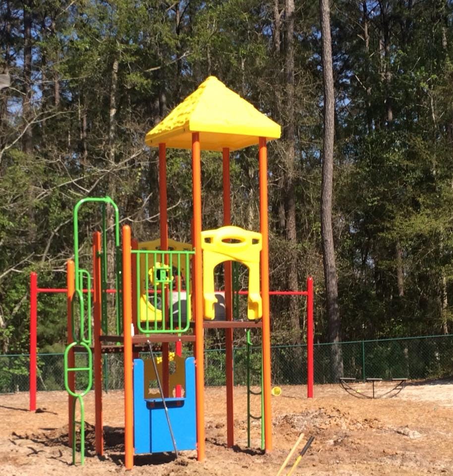 Colorful playground structure with slides and climbing elements