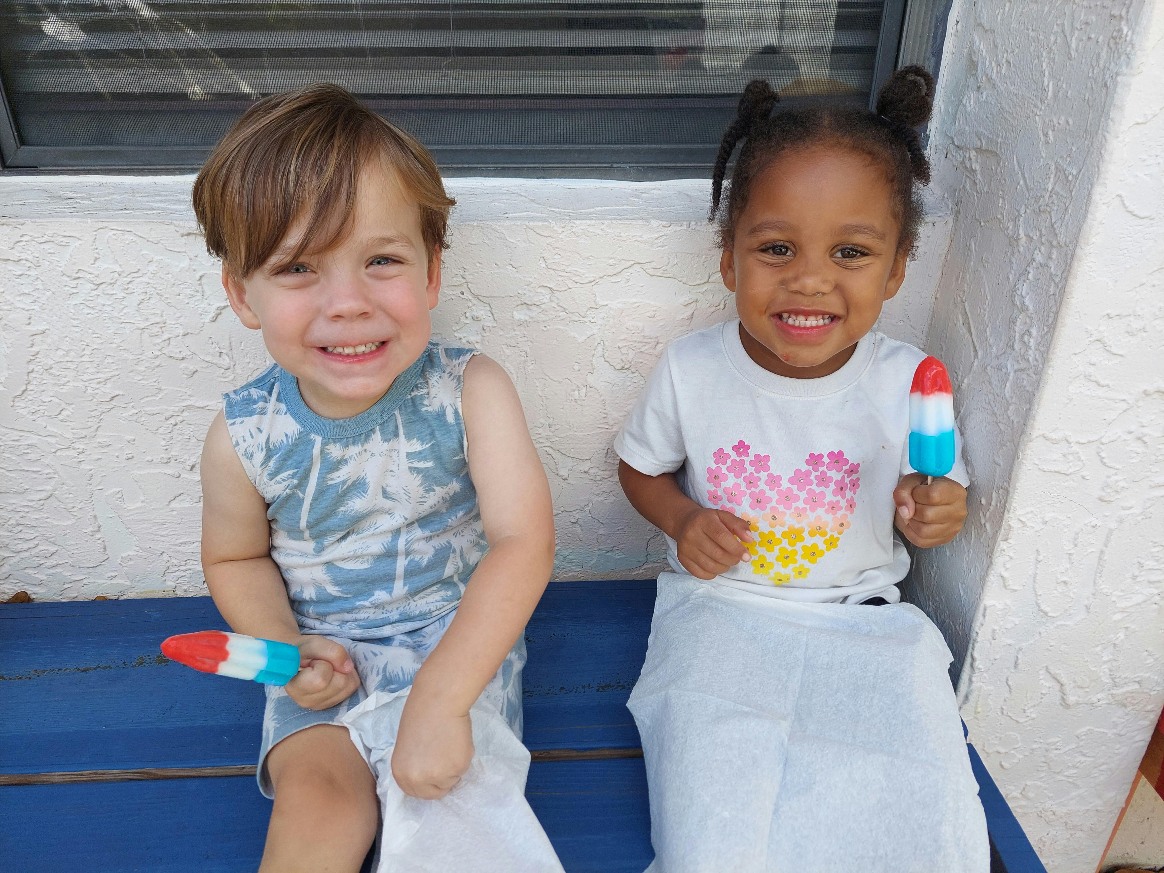 Two children holding popsicles