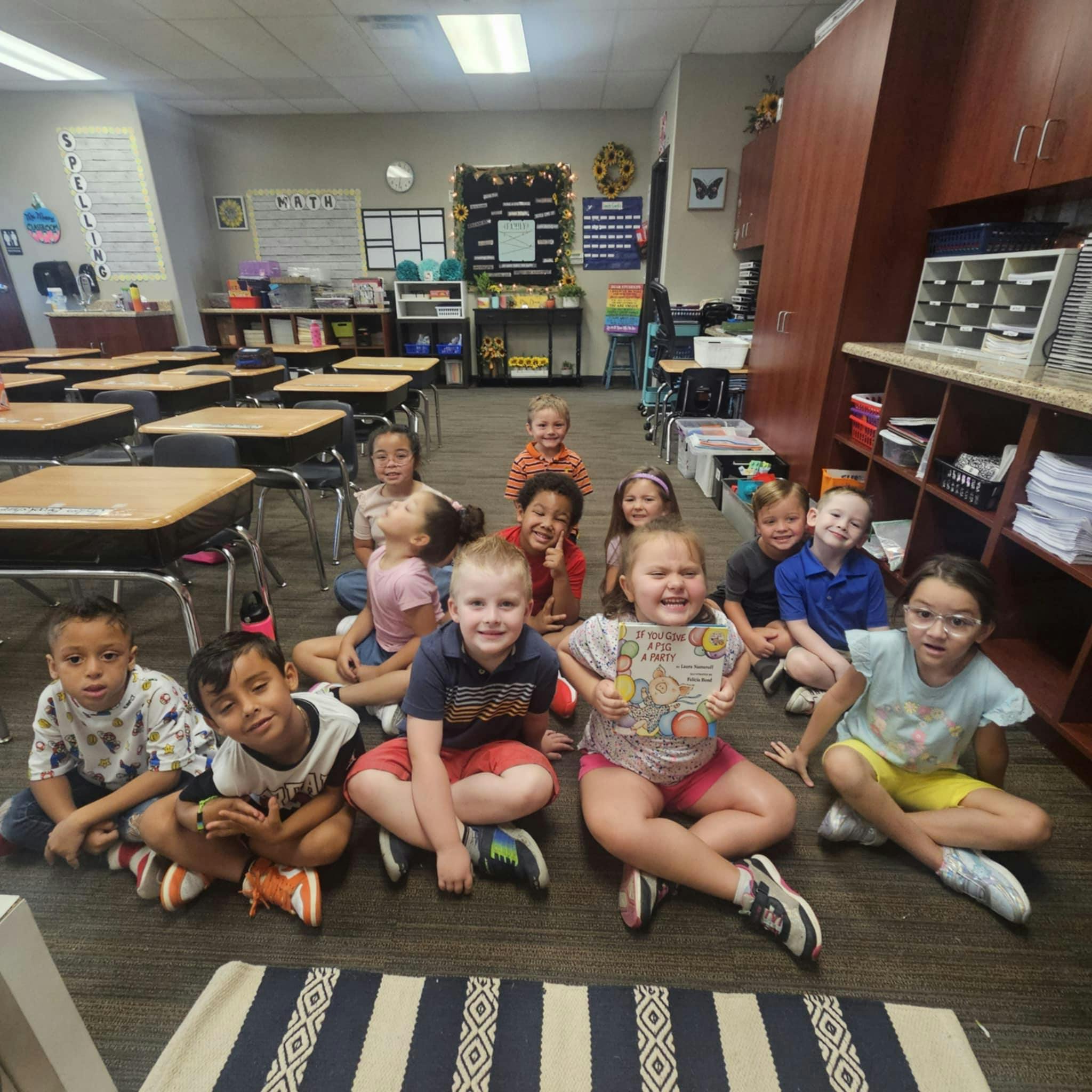 Group of children sitting on the floor in a classroom