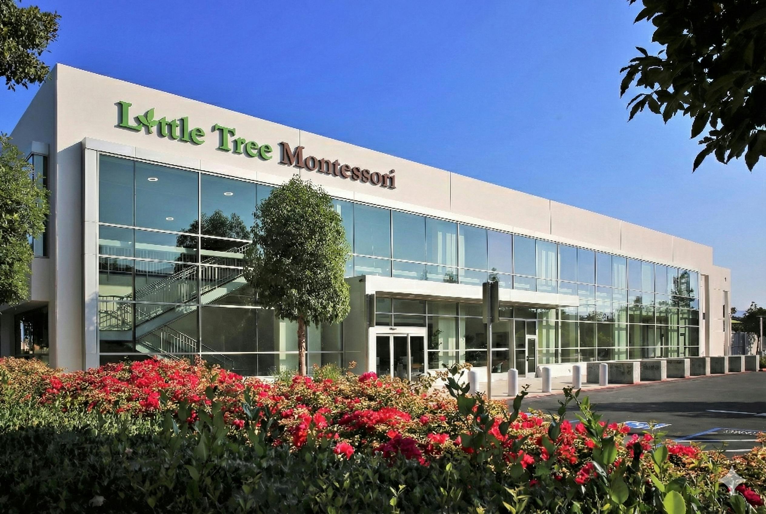 Little Tree Montessori building exterior with glass facade and red flower bed