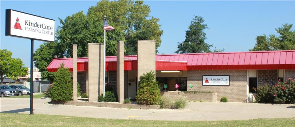 KinderCare Learning Center building with red roof and signs