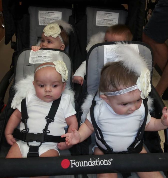 Multiple babies in strollers, some wearing headbands and white outfits
