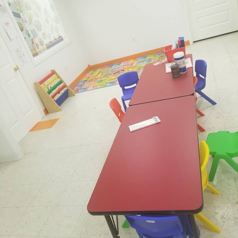 Classroom with red tables and colorful chairs