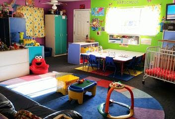 Childcare room with play area and small tables