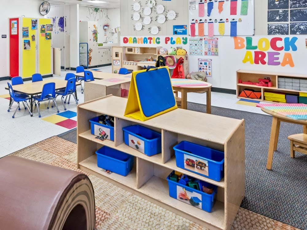 An empty early childhood classroom with designated activity areas