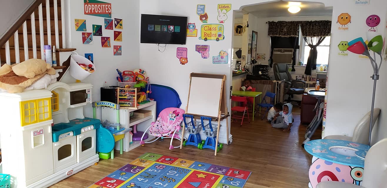 Playroom with toys, a play kitchen, and a child on the floor