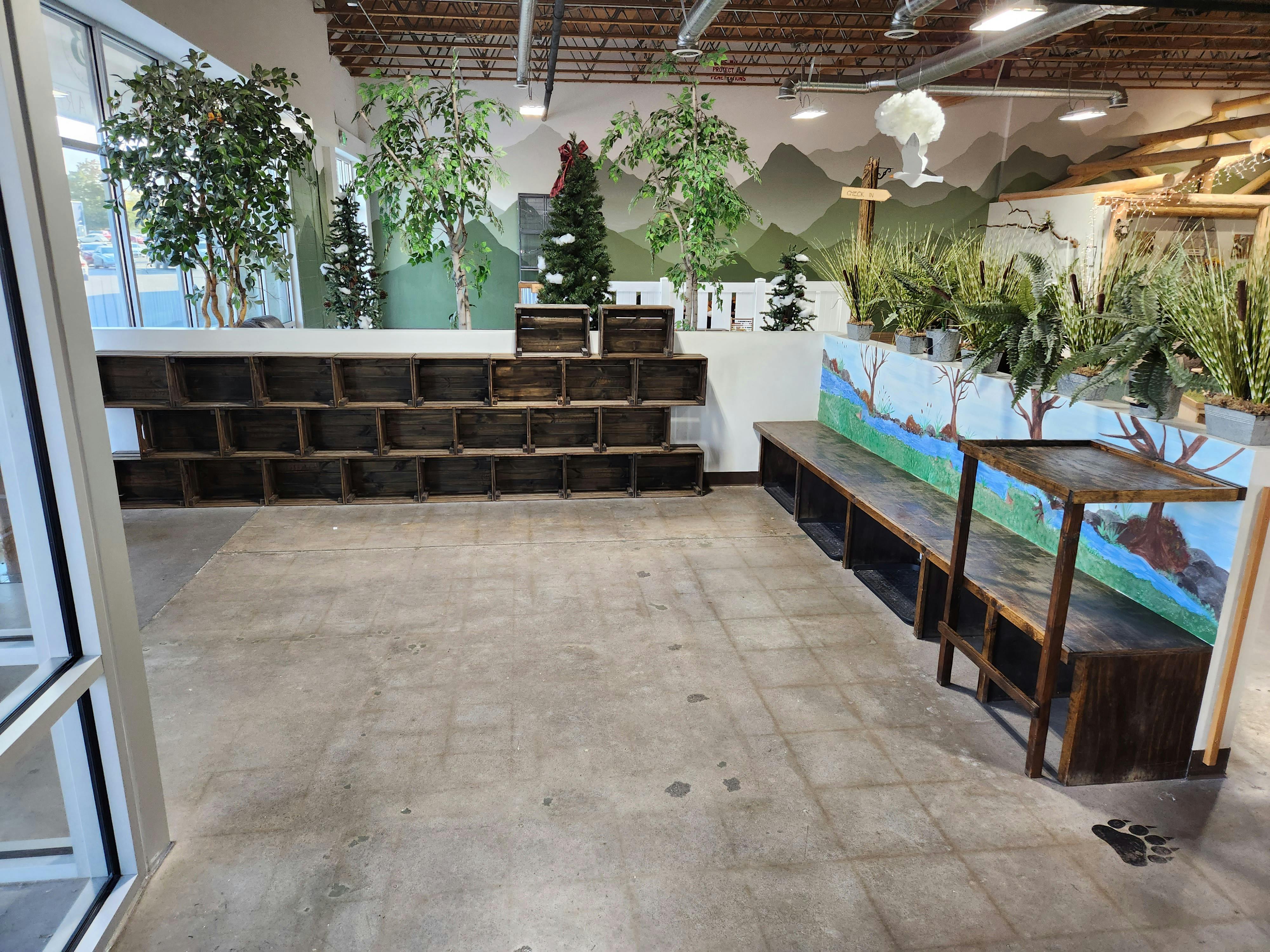 Indoor space with wooden cubbies, benches, and artificial plants