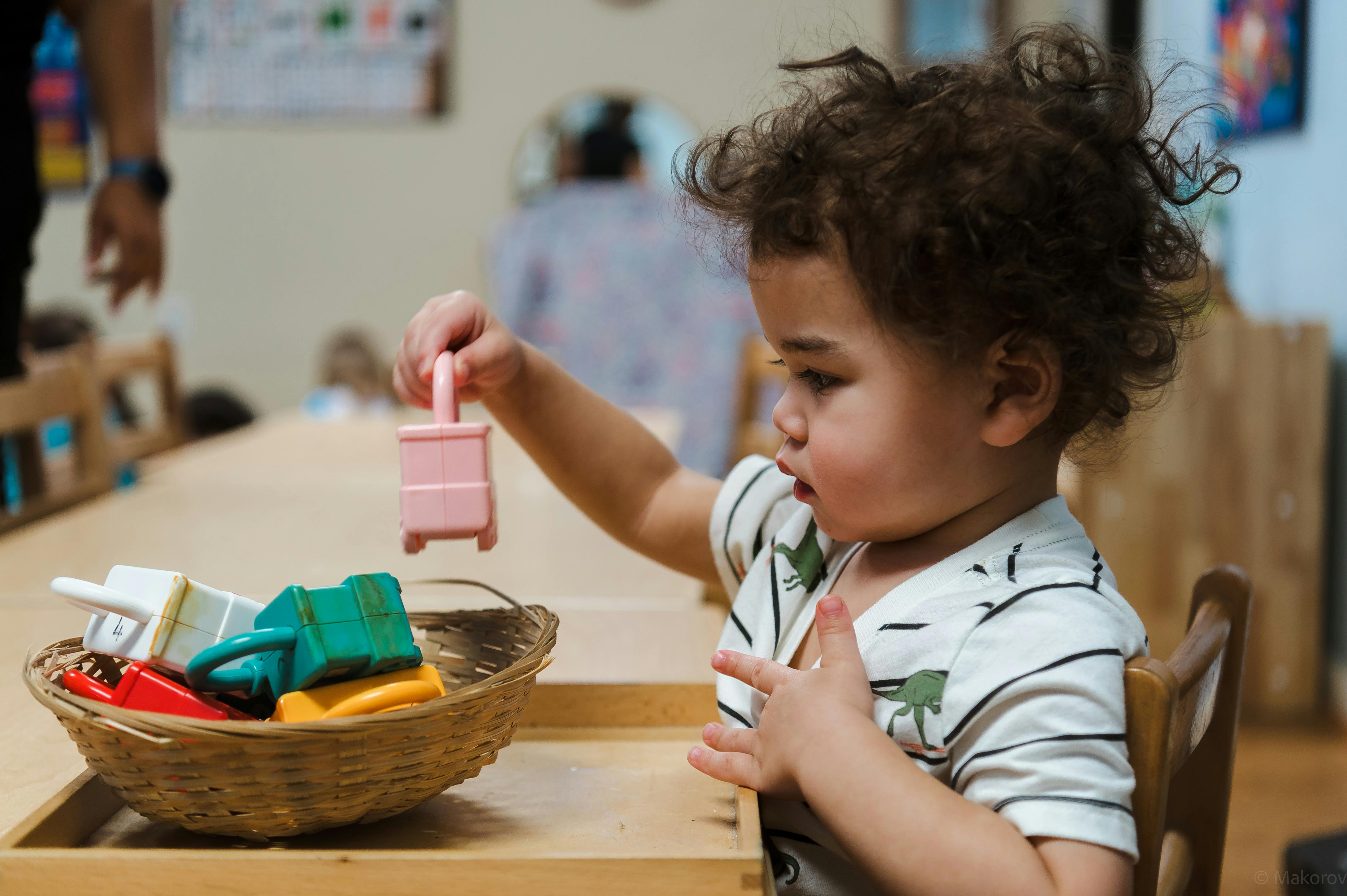 Child playing with toy blocks in a classroom