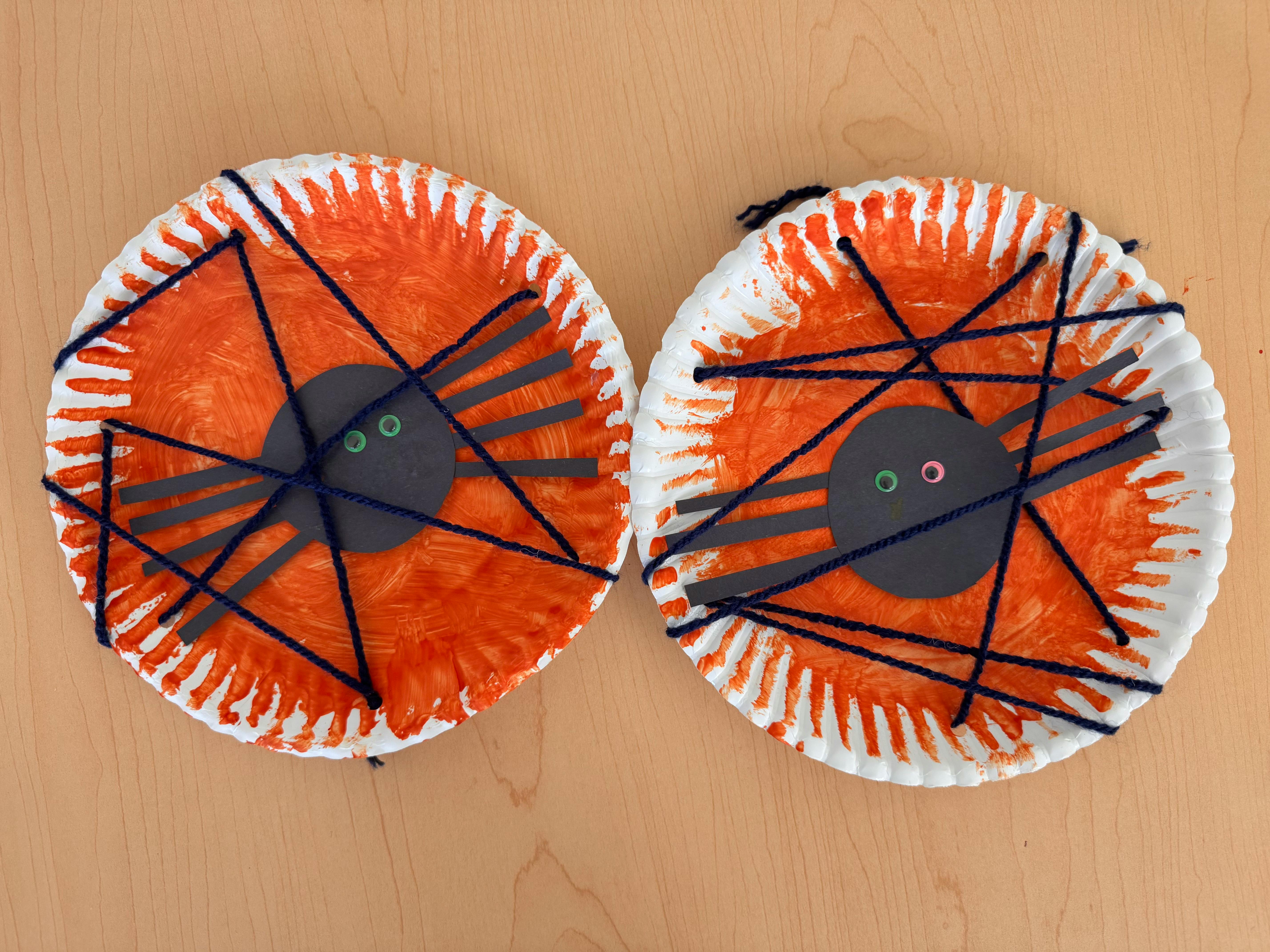 Two paper plate spider crafts with yarn webs