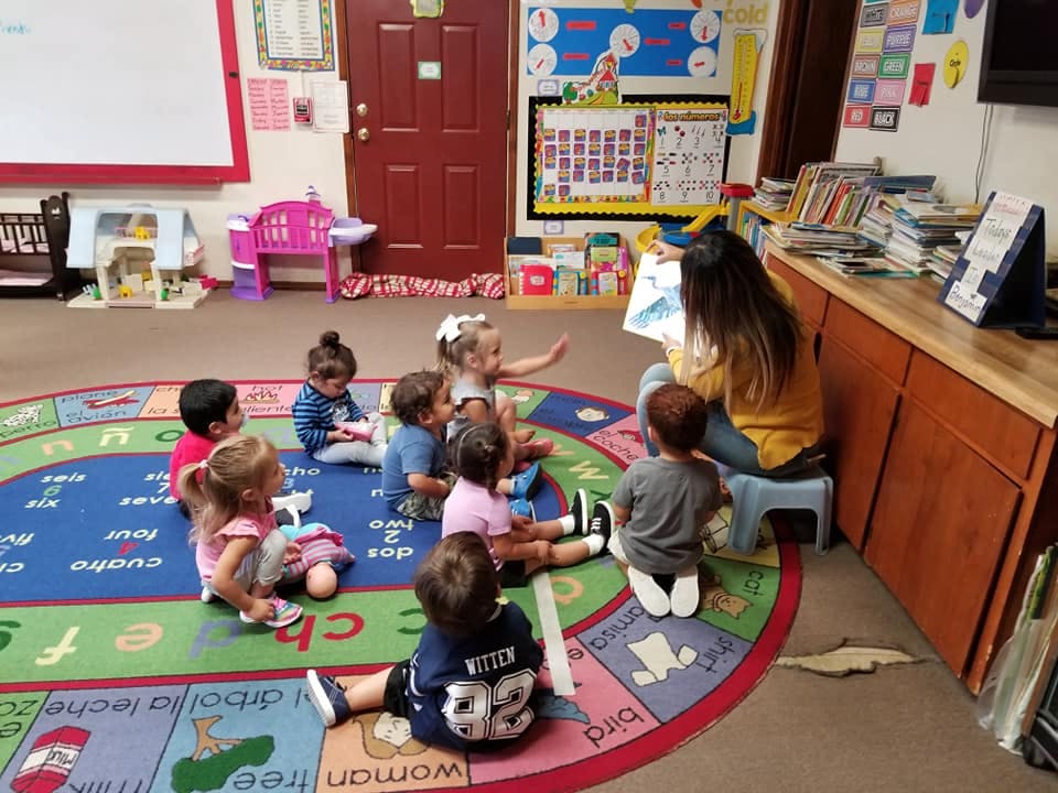 Person reading to children in a classroom