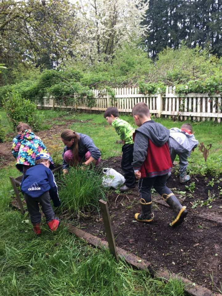 Adult and children gardening outdoors