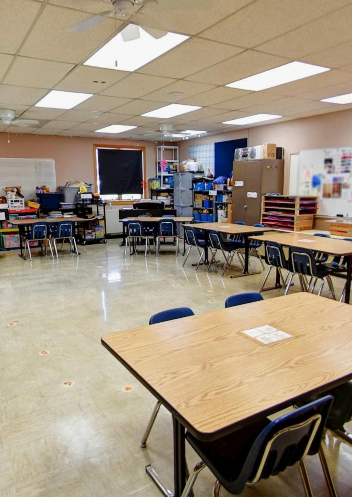Empty classroom with tables and chairs arranged in rows