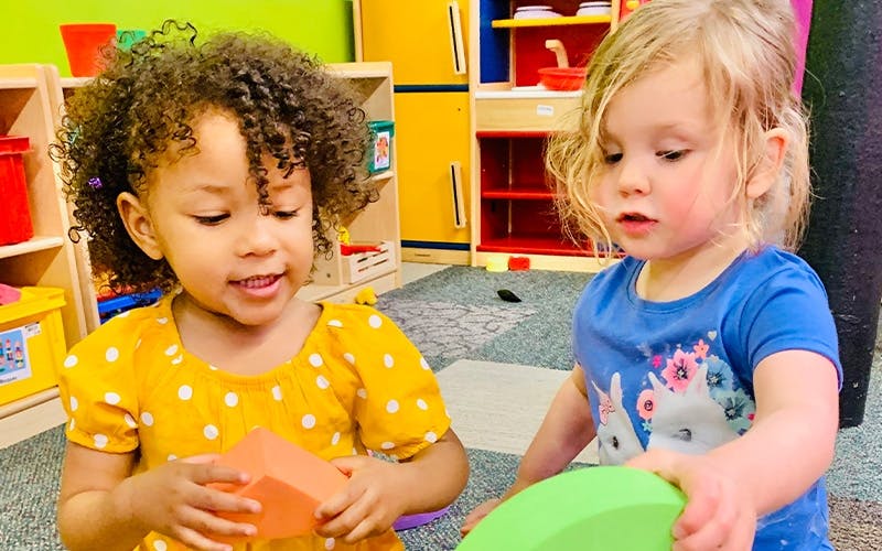Two children playing with blocks