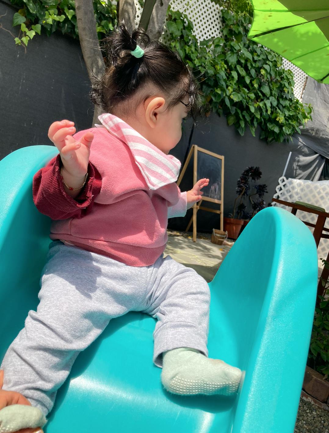 Child sitting on a blue slide