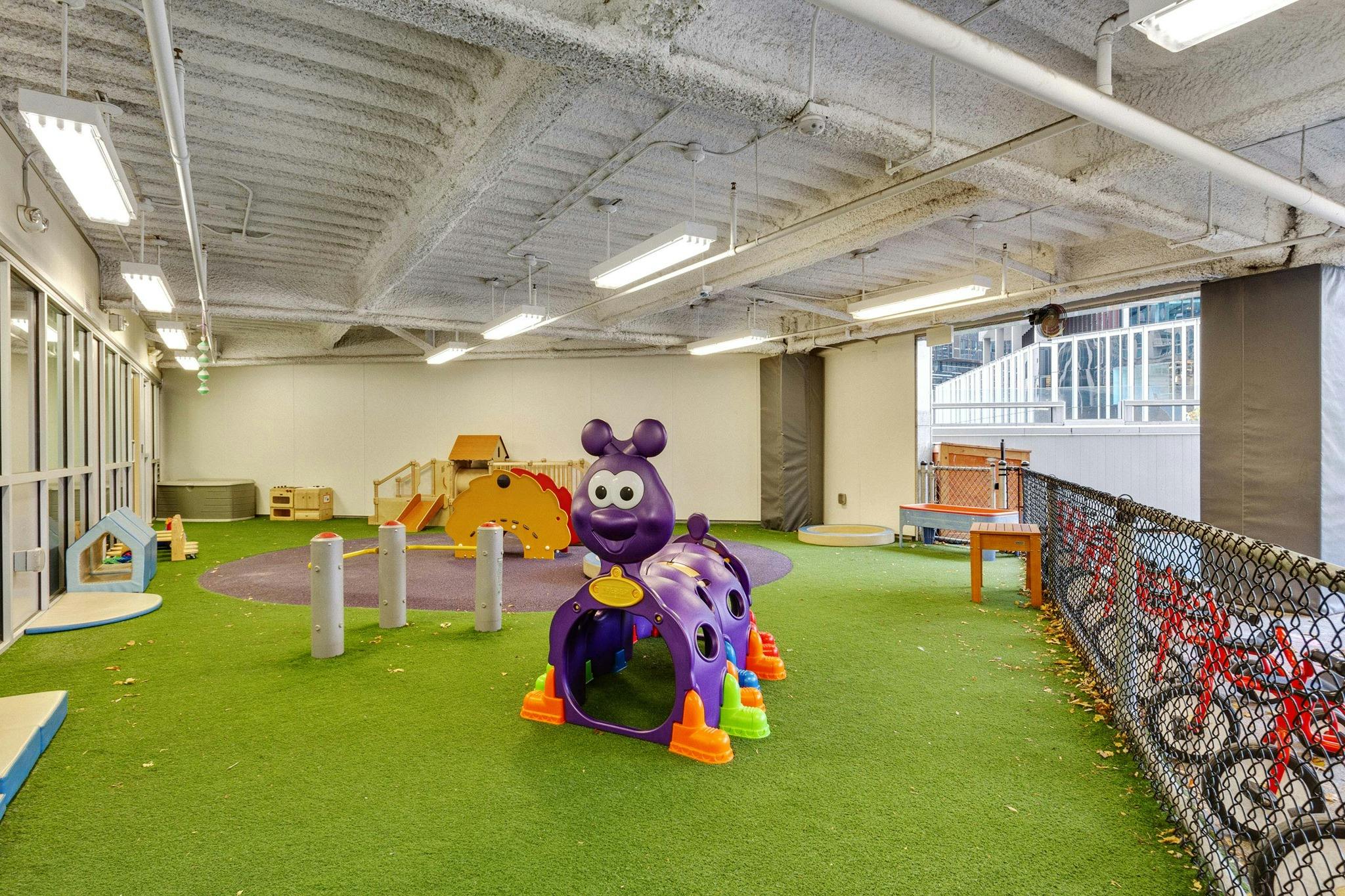 Indoor playground with purple caterpillar toy and yellow slide