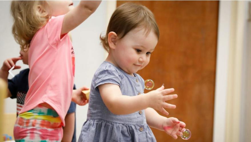 Child reaching for bubbles