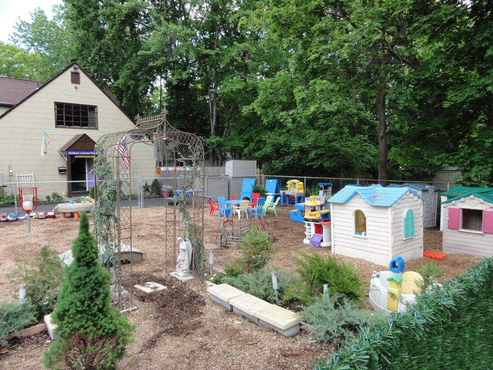 Outdoor play area with small houses and colorful chairs