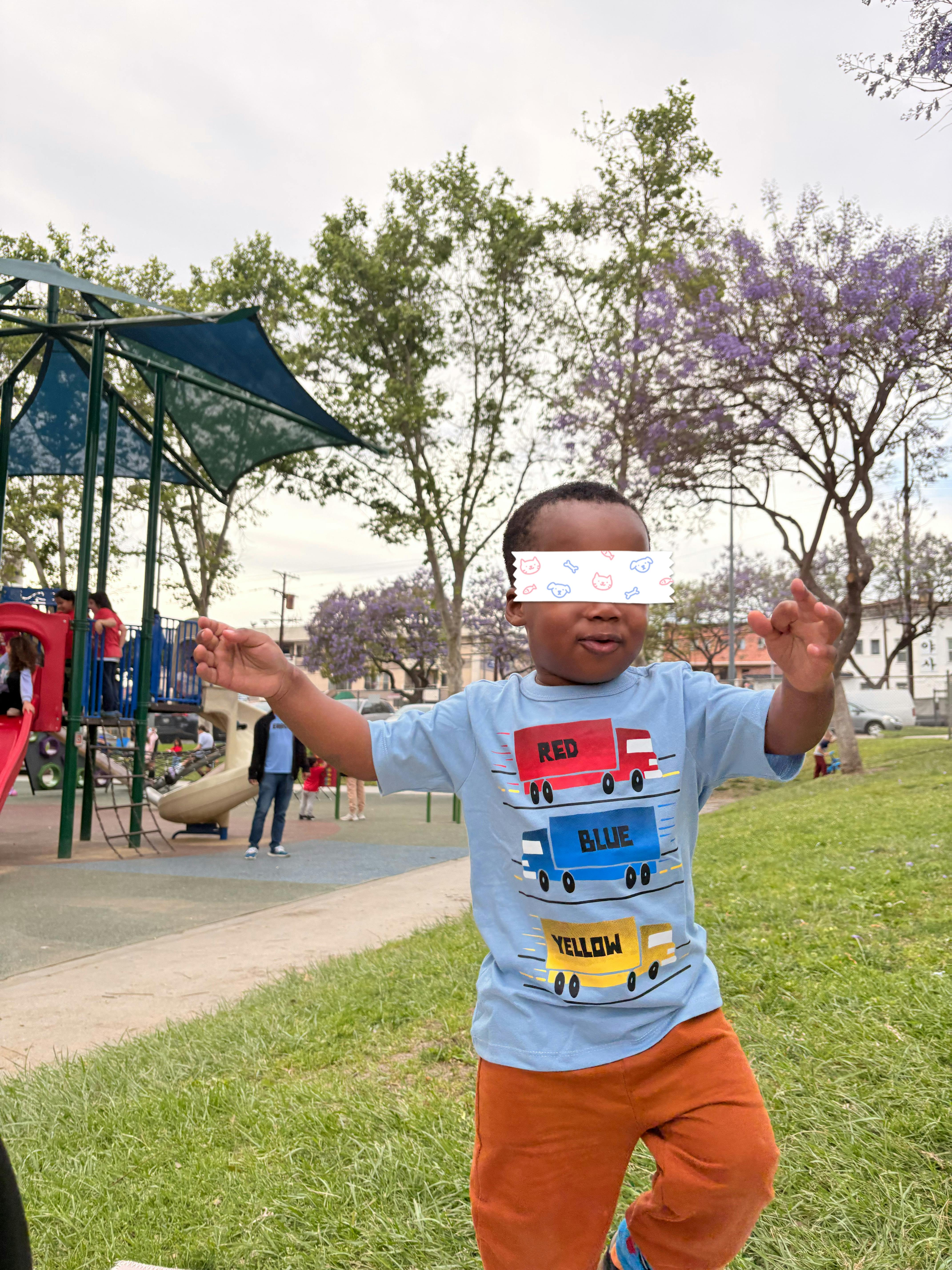 Child running on grass at a playground