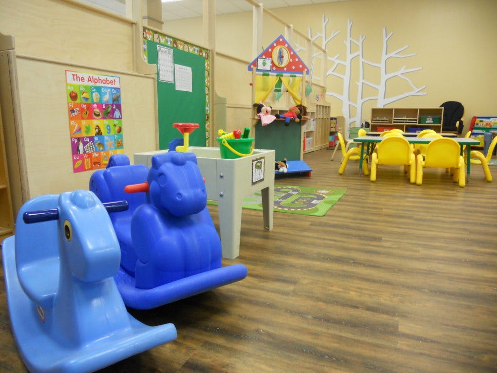 Two blue rocking toys in a classroom